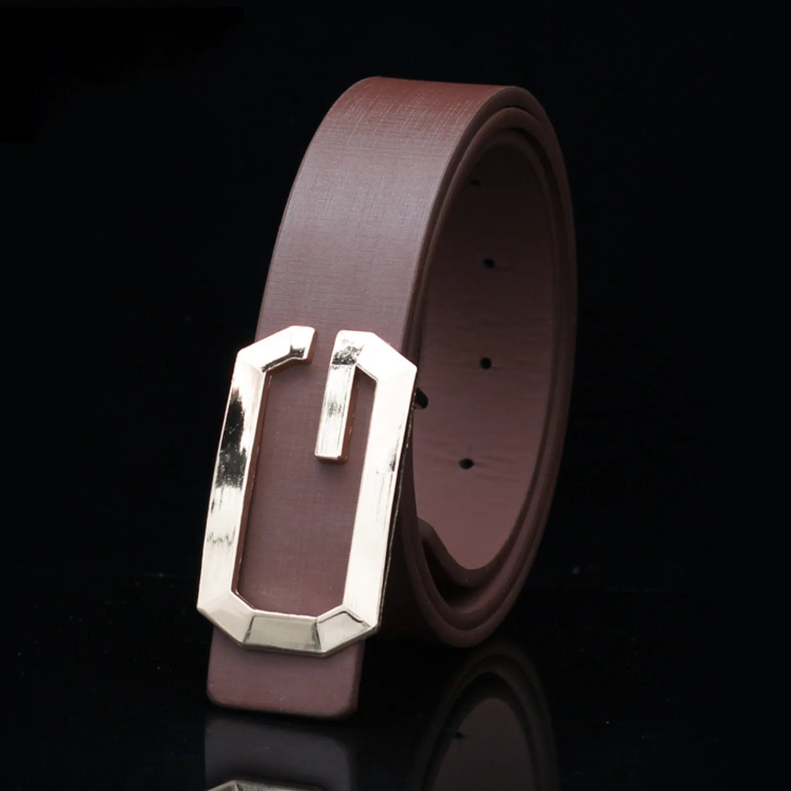 Brown leather belt with a silver buckle on a black background