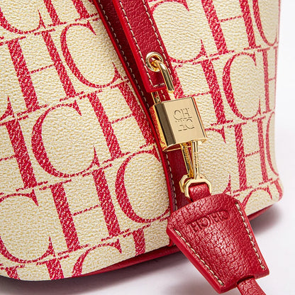 Close-up of a red and beige handbag with a gold clasp on a white background
