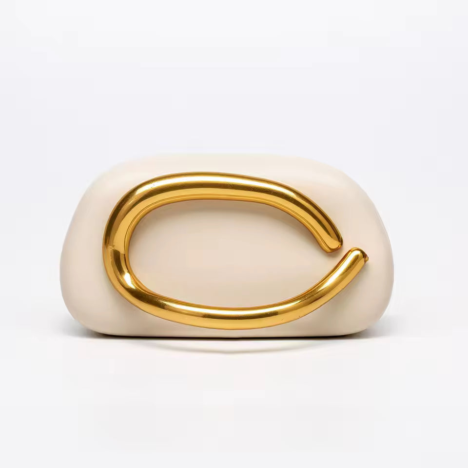 Cream-colored ring with a gold band on a white background