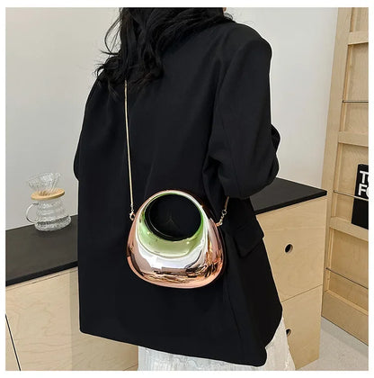 Person wearing a black coat with a unique handbag featuring a green interior.