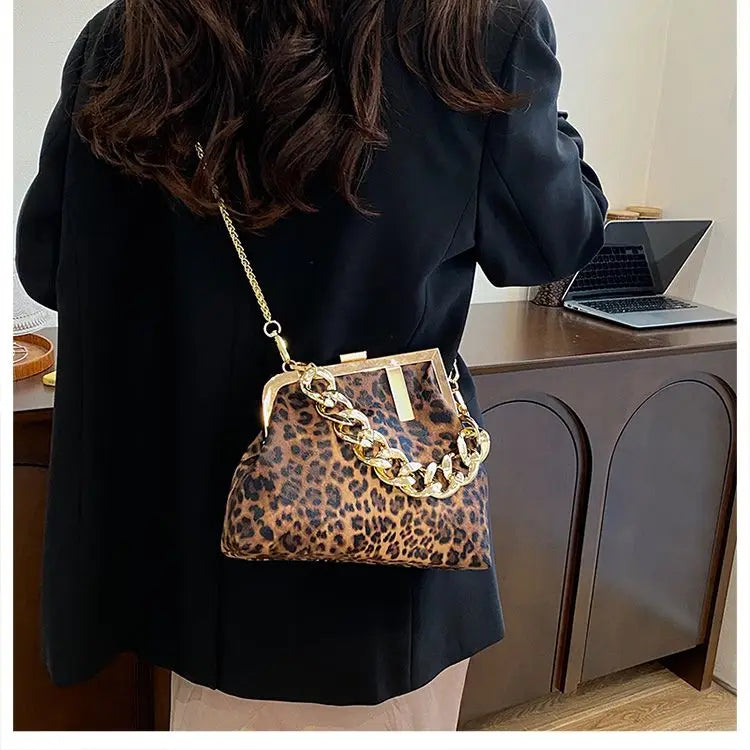 girl wearing a Carauana_UNIU_Leopard_Clutch with gold chain detail