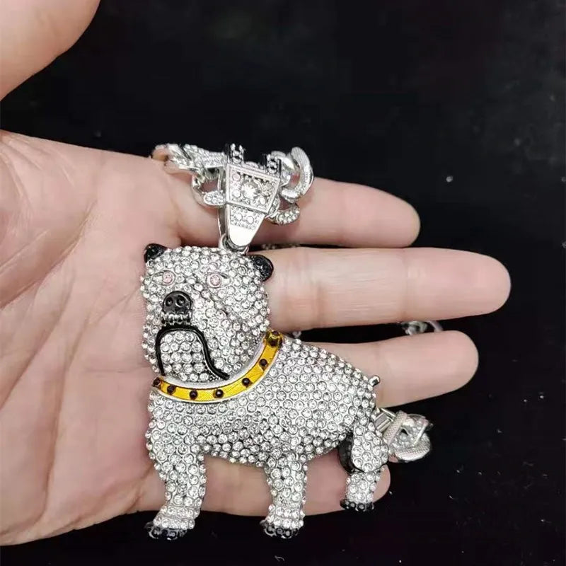 Dog-shaped pendant with rhinestones held in a hand against a dark background