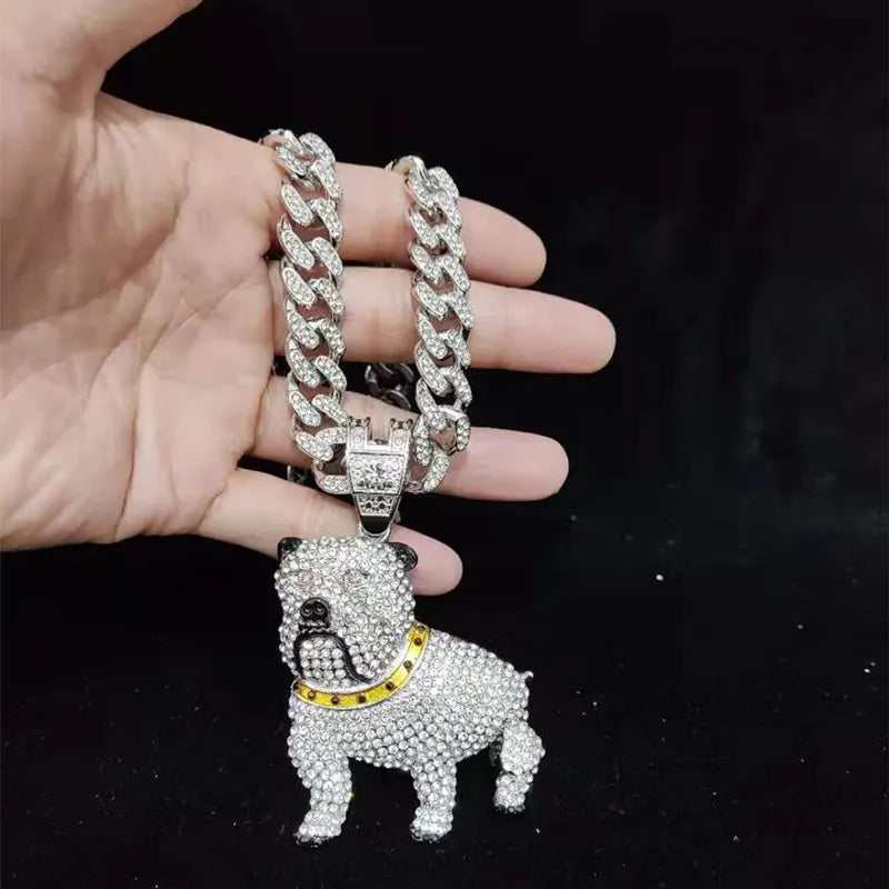 Hand holding a diamond-encrusted bulldog pendant with a chain