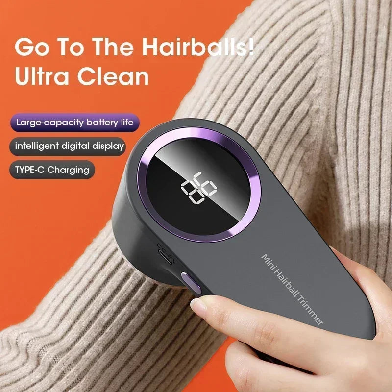 Hand holding a mini hairball trimmer with digital display