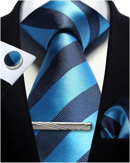 Blue and black striped tie with matching pocket square and cufflinks on a suit.