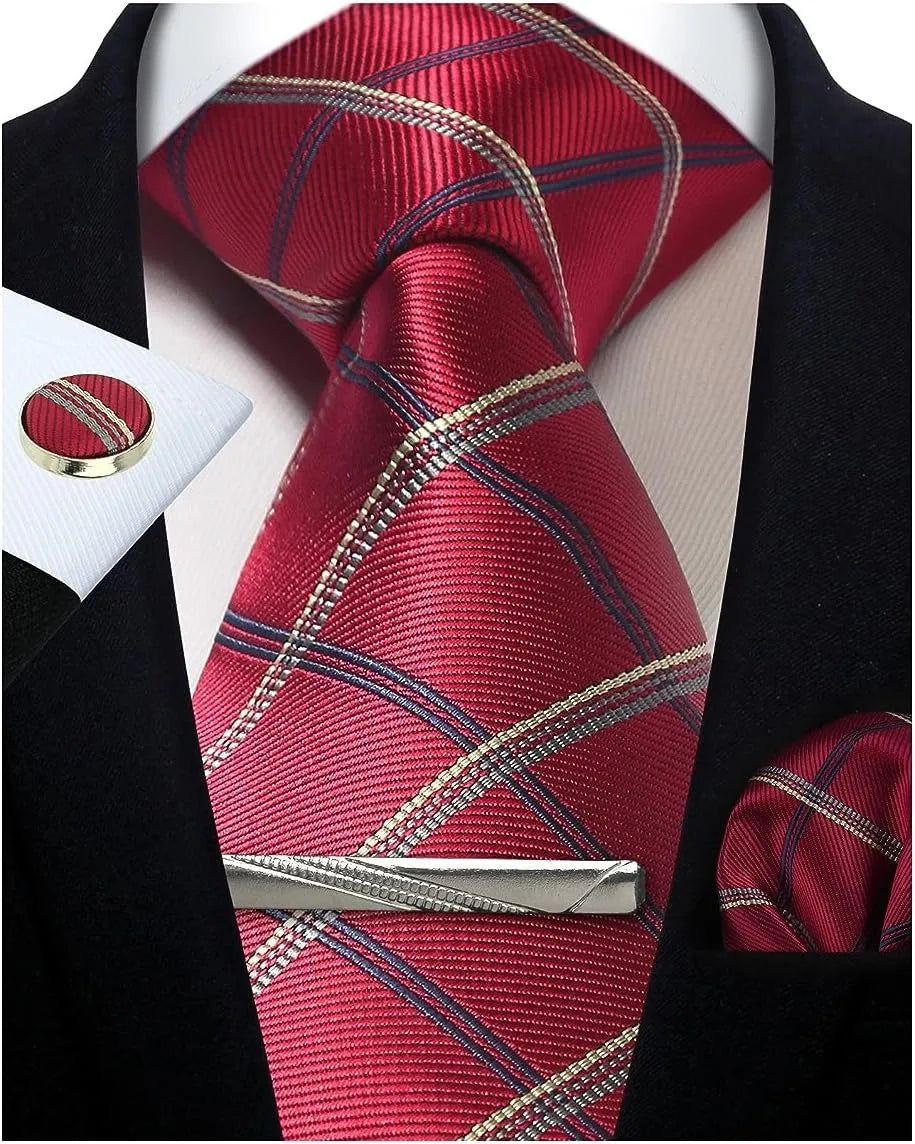 Red plaid tie with gold accents, matching pocket square, and tie clip on a black suit jacket.