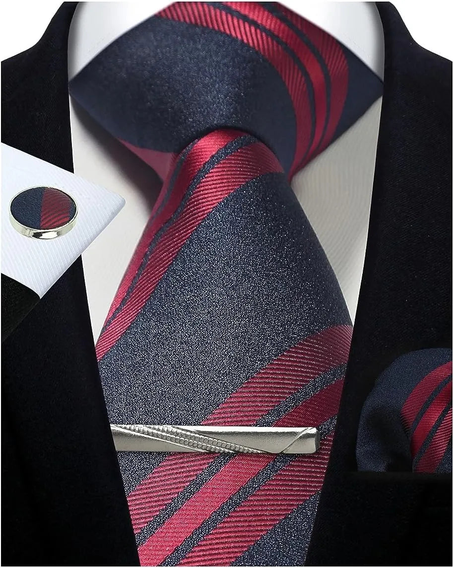 Navy and red striped tie with matching pocket square and tie clip on a black suit jacket.