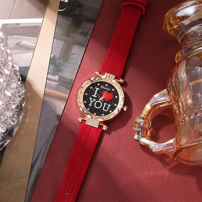 Watch with red strap and 'I LOVE YOU' display on a reflective surface